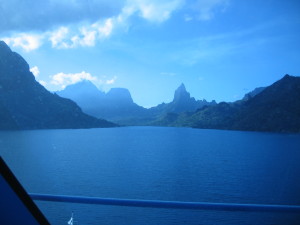 Mountainous landscape with lake under blue sky.