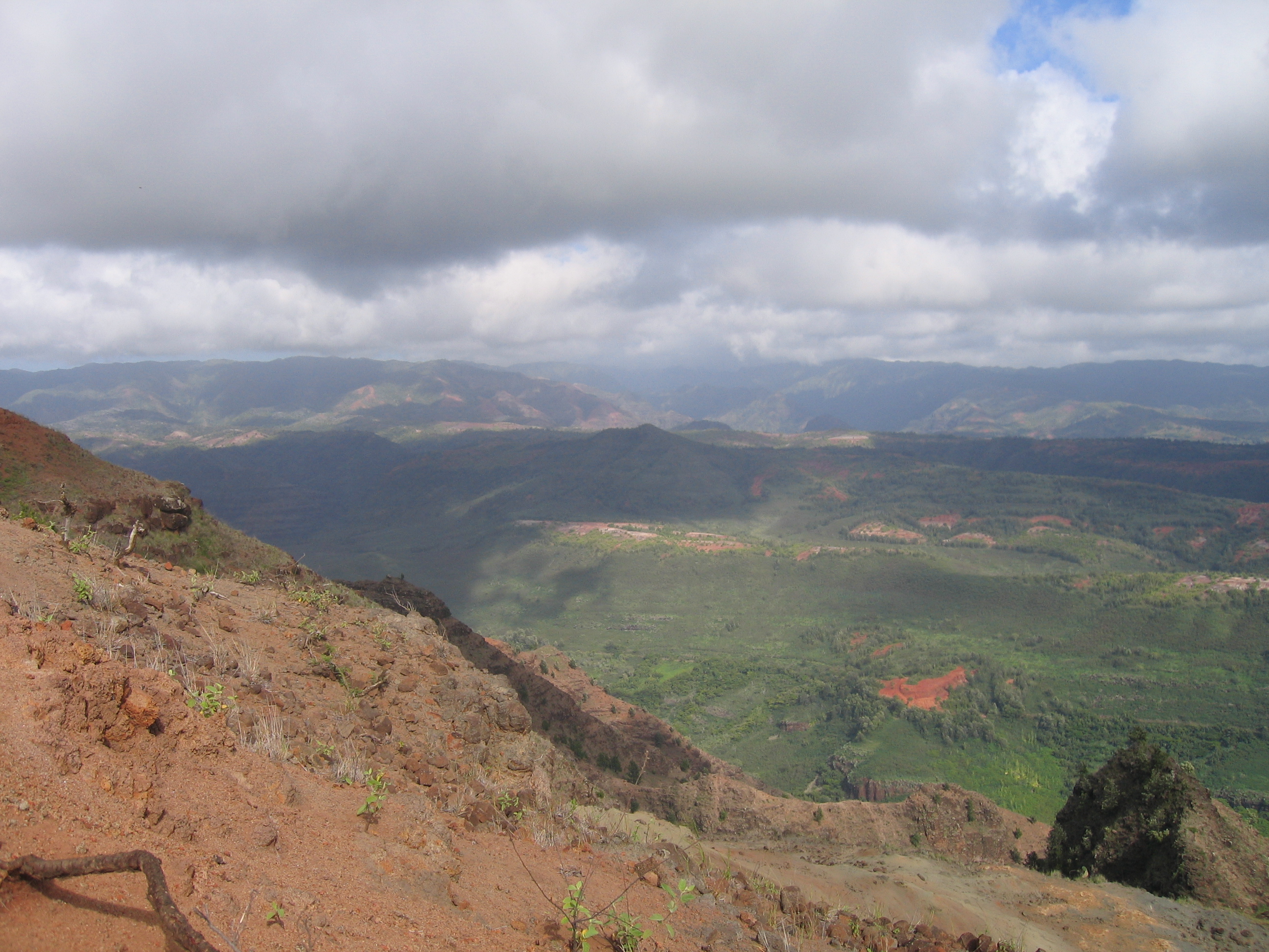 Mountain landscape with cloudy sky above valley.