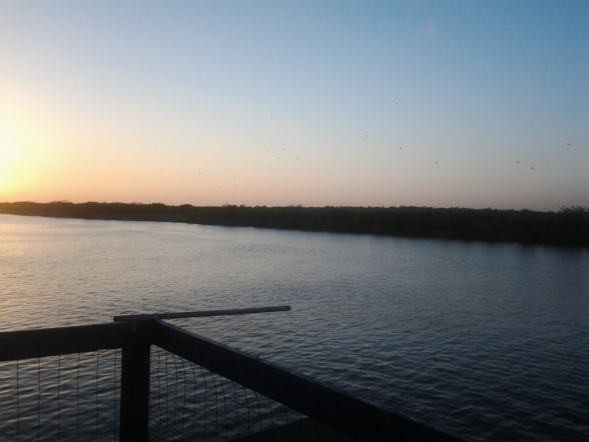 Sunset view over calm river waters.