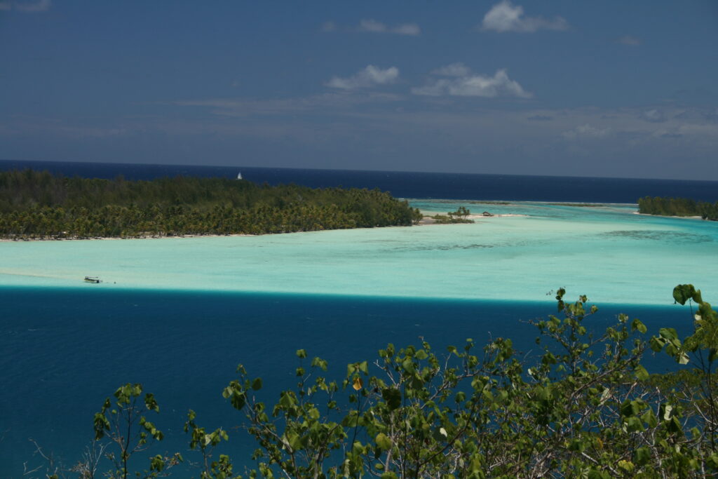 Tropical island with turquoise and blue waters.
