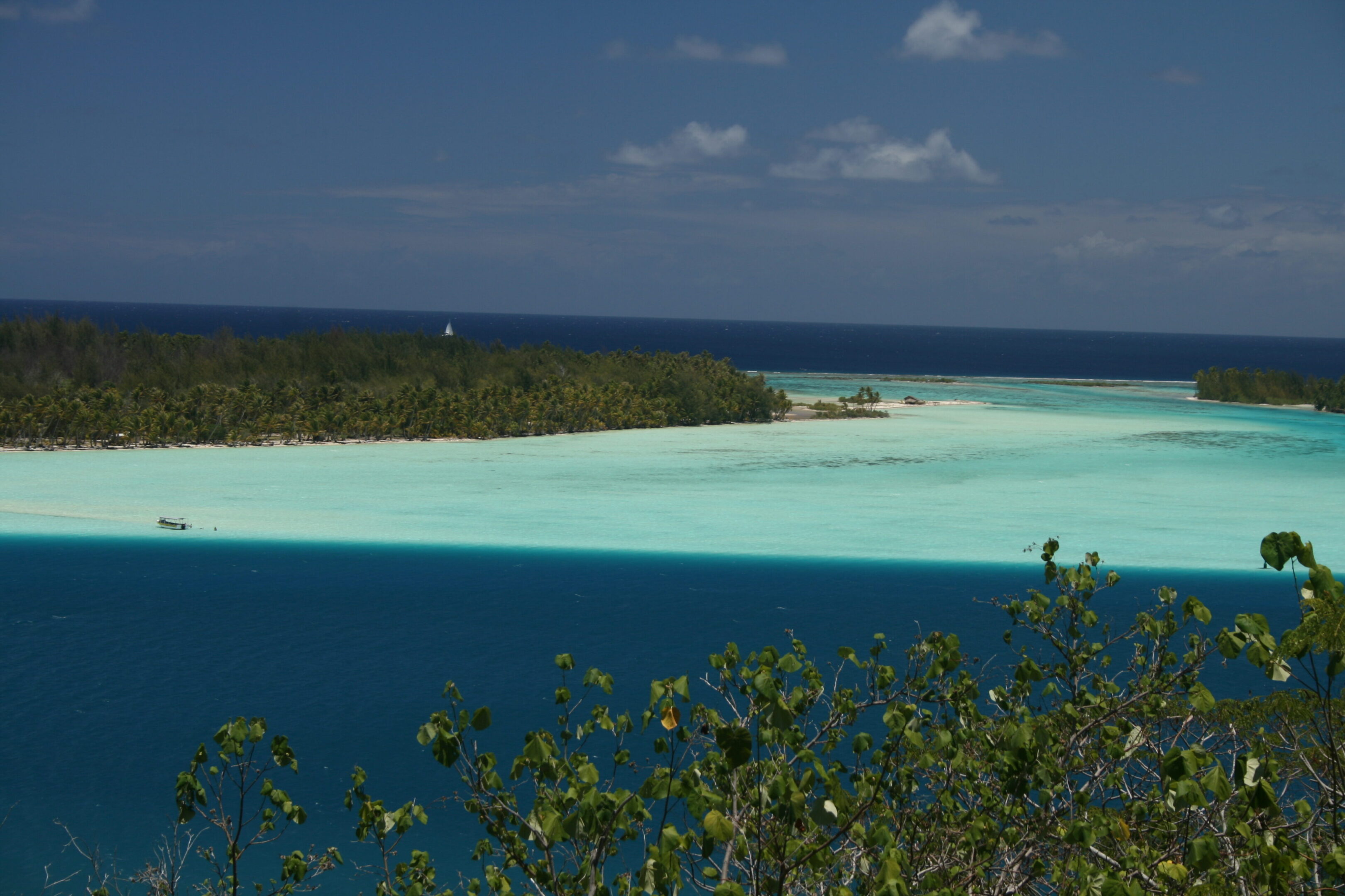 Tropical island with turquoise and blue waters.