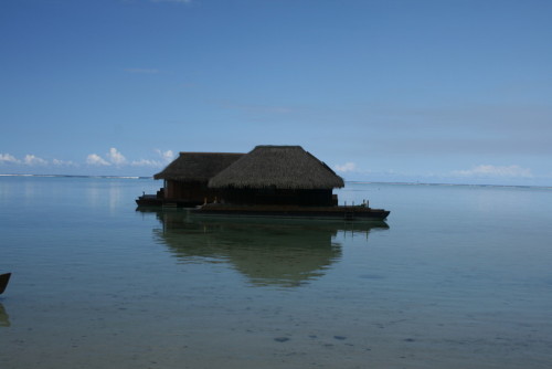 Overwater bungalows on calm, clear water.