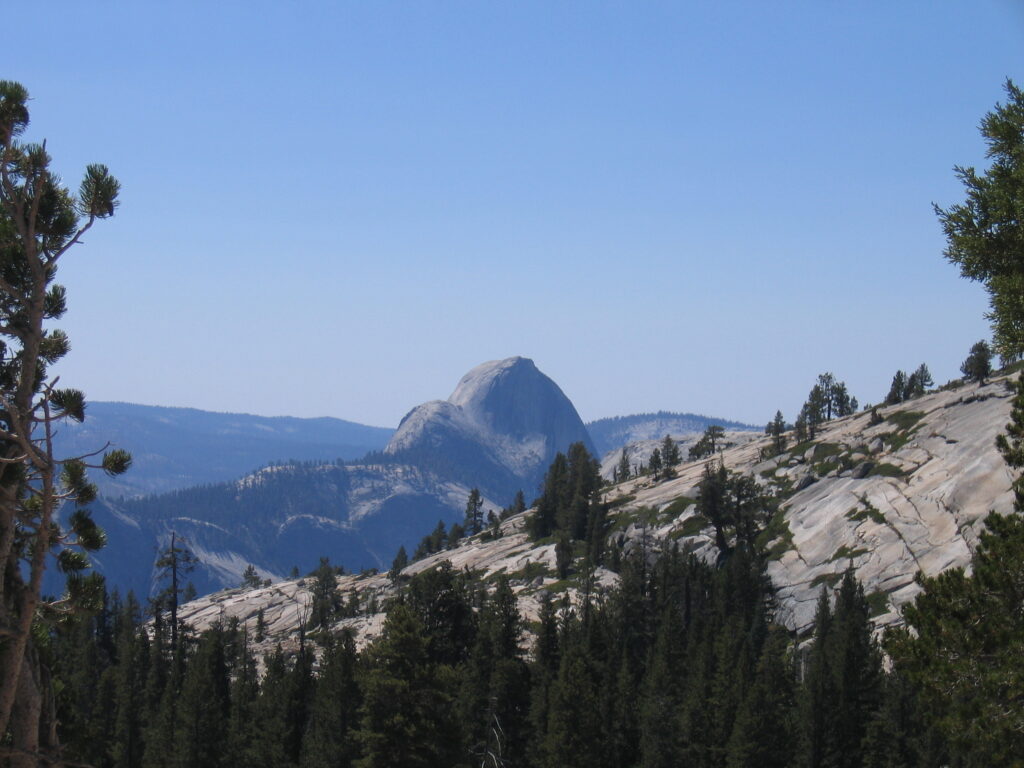 Mountain landscape with Half Dome in distance.