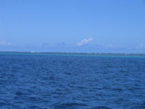 Blue ocean under clear sky horizon.