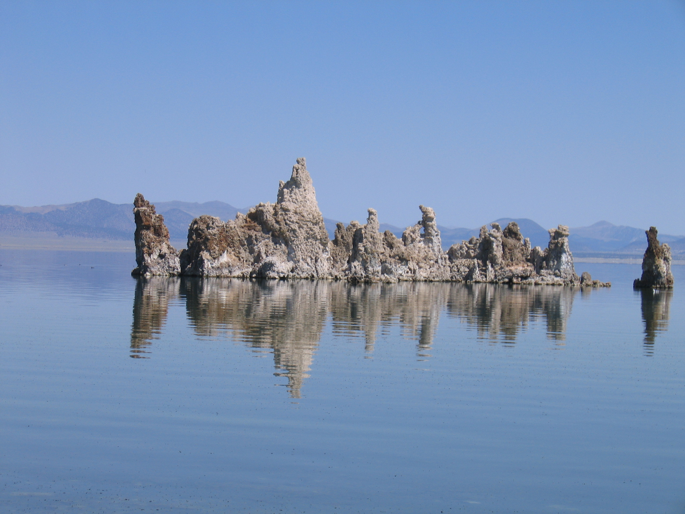 Rock formations in a calm blue lake.