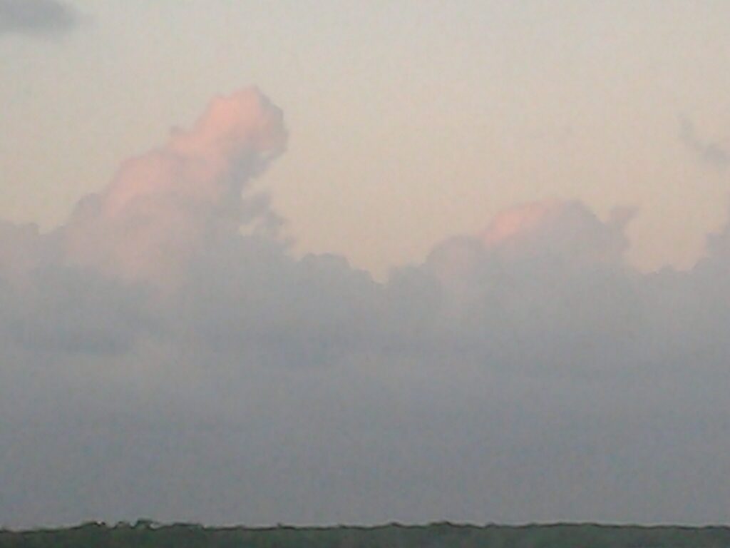 Pink clouds in a blue sky.