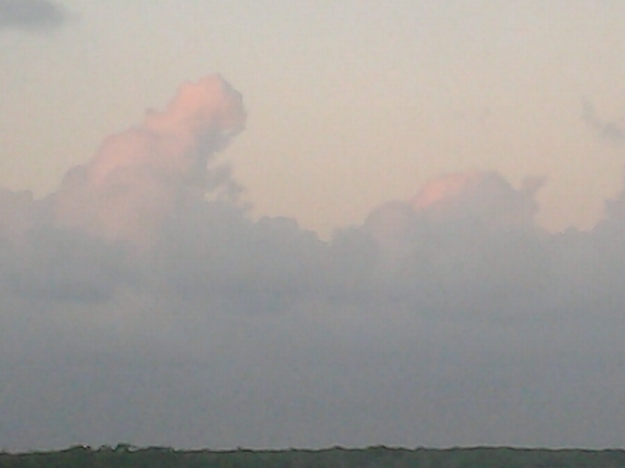 Pink clouds in a blue sky.