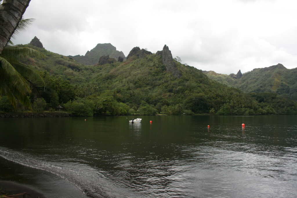 Mountainous landscape with lake and cloudy sky.