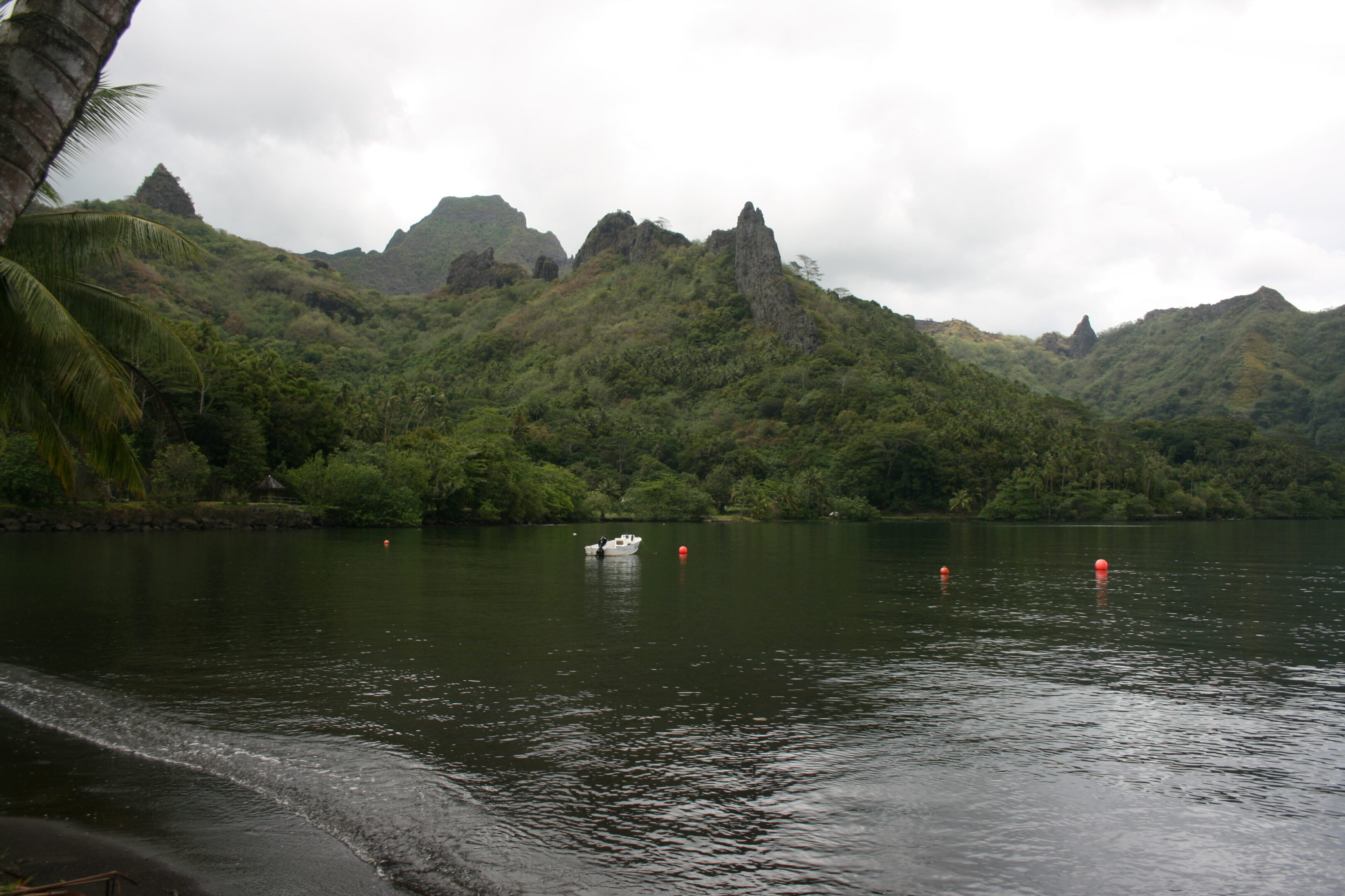 Mountainous landscape with lake and cloudy sky.