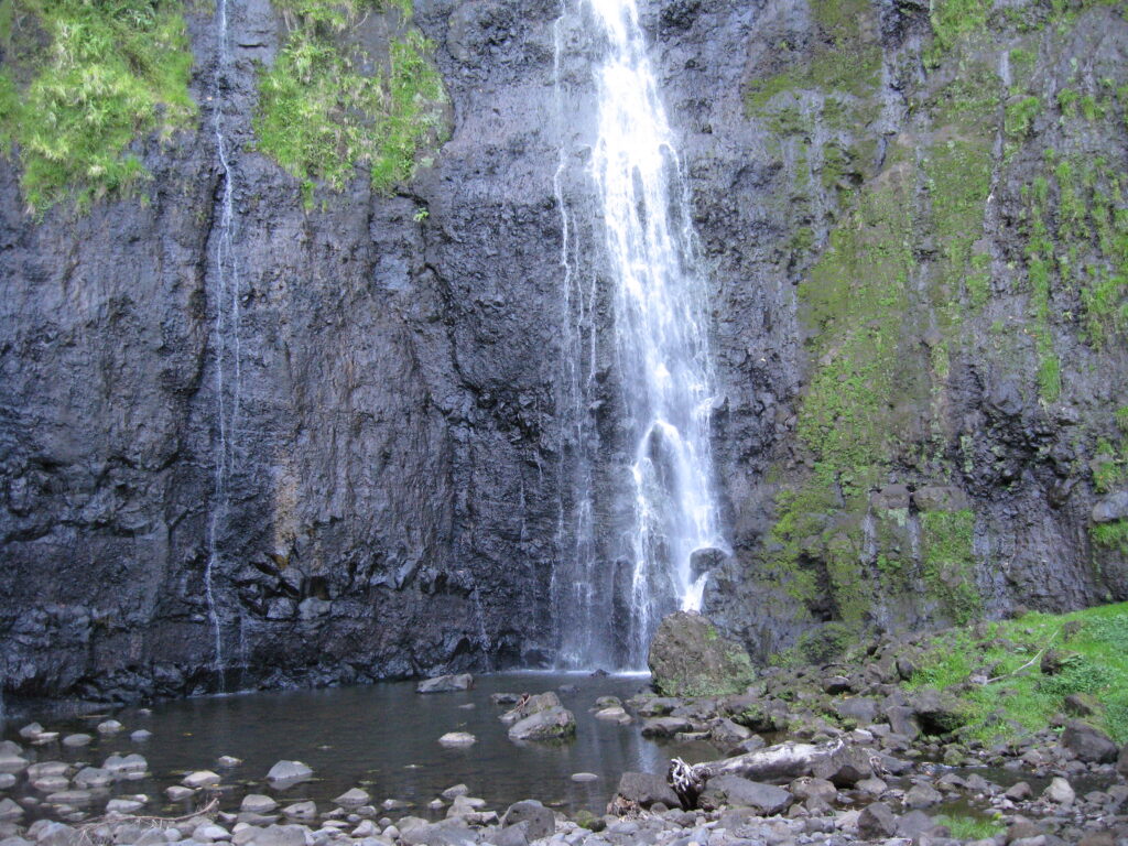 Waterfall cascading down a rocky cliff.