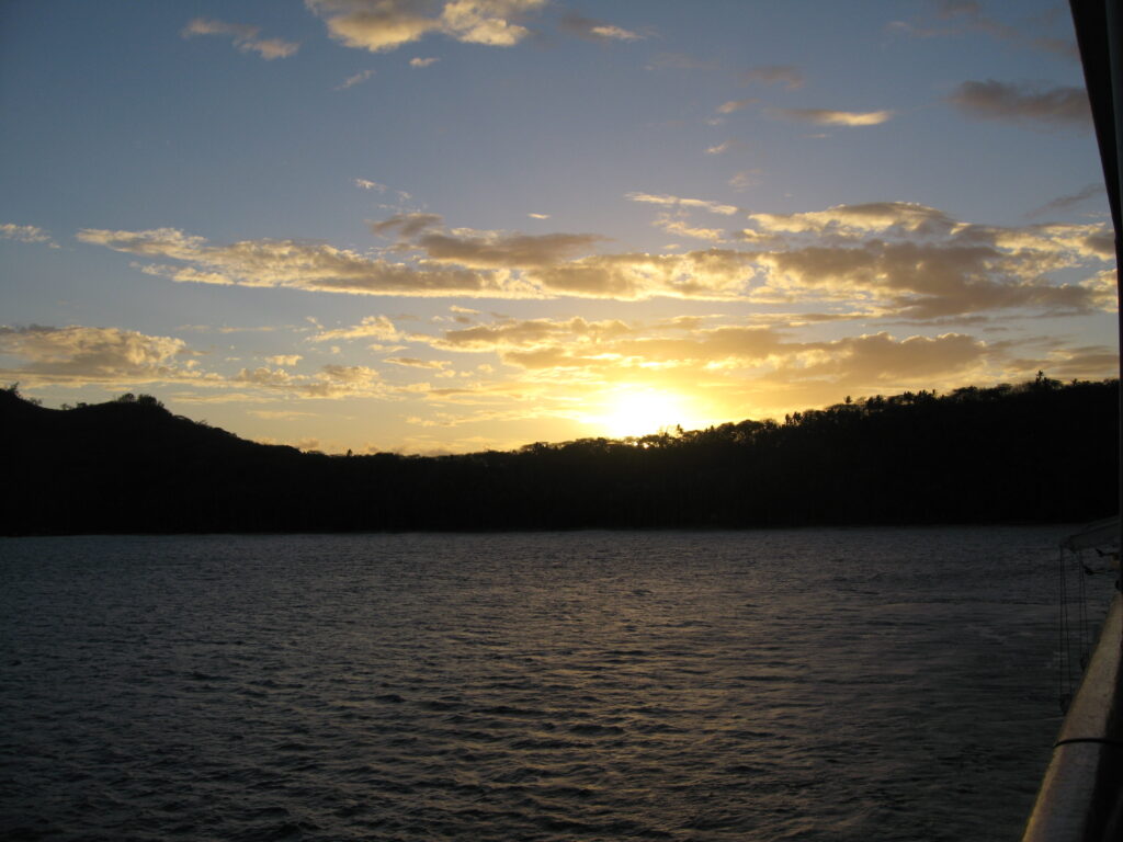Sunset over a calm, darkened lake.