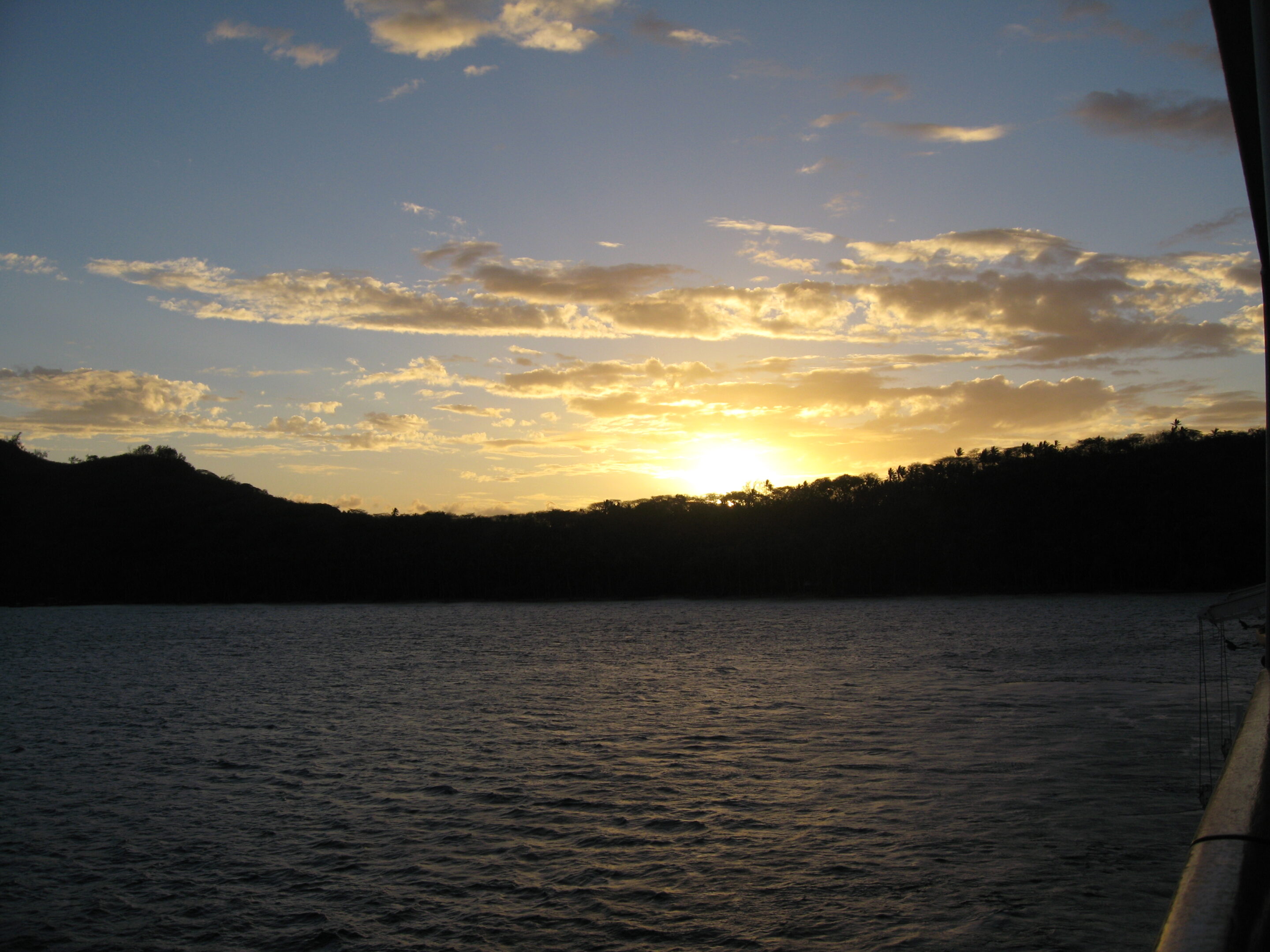Sunset over a calm, darkened lake.