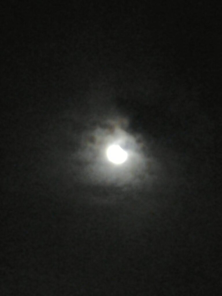 Cloudy night sky with a bright moon.