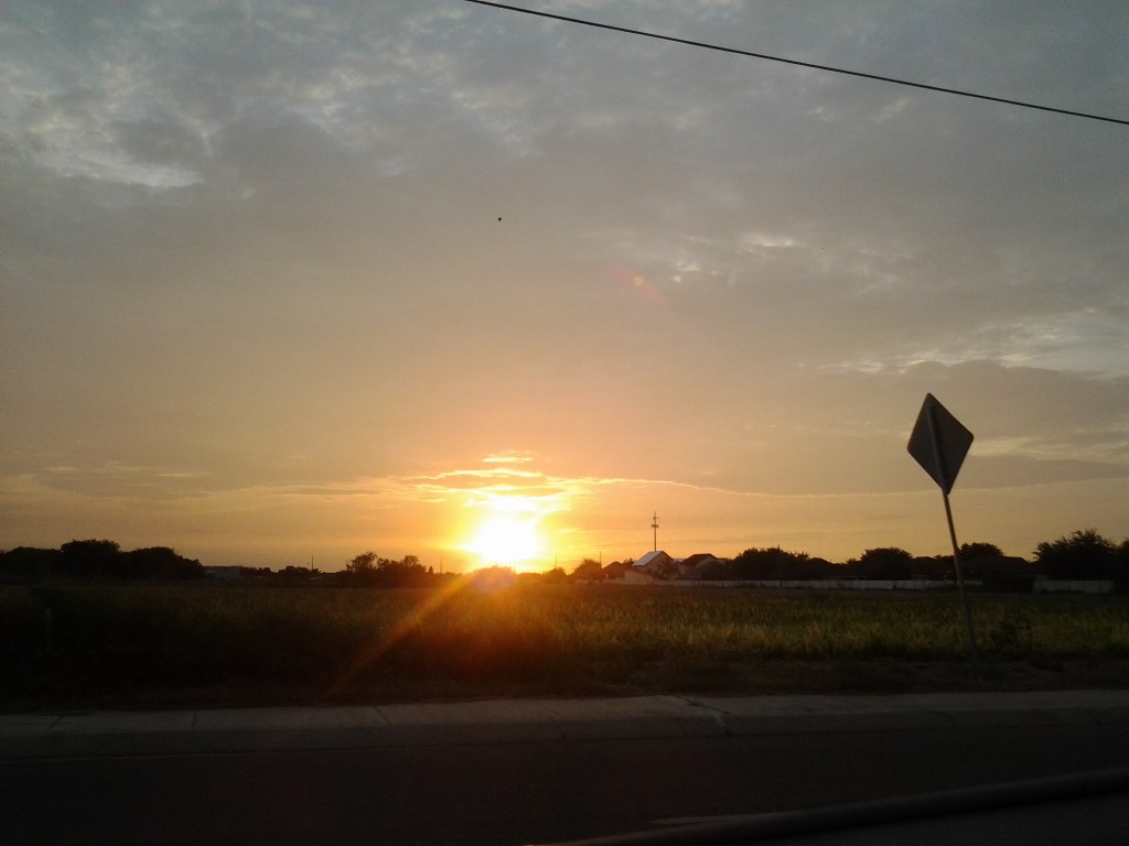 Sunset over a rural landscape with sign.