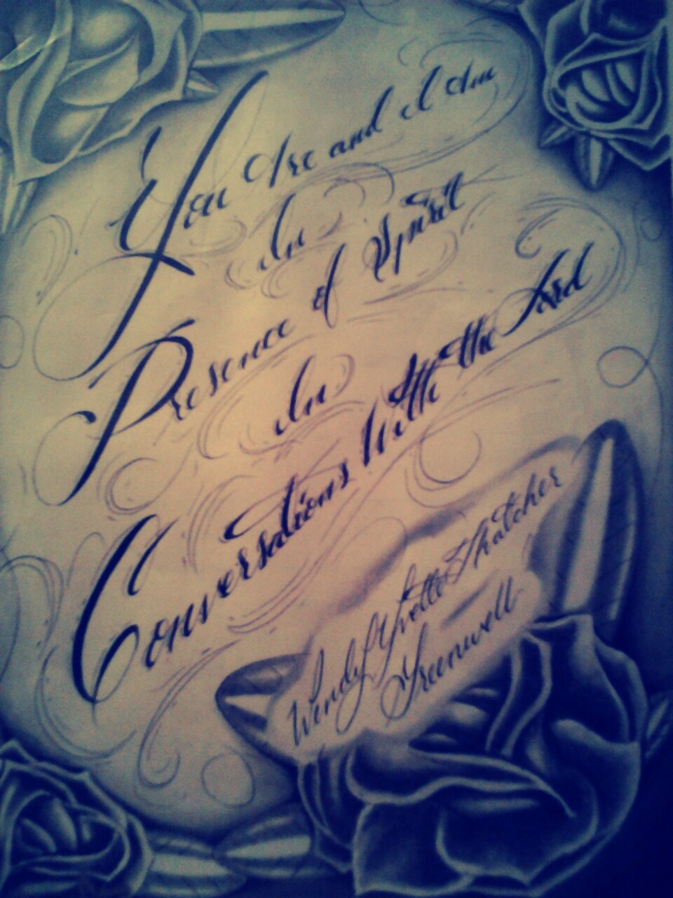 Decorative script with roses and text.