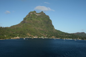 Mountain view with ocean and clear sky.
