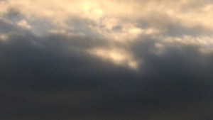 Cloudy sky with hints of sunlight.