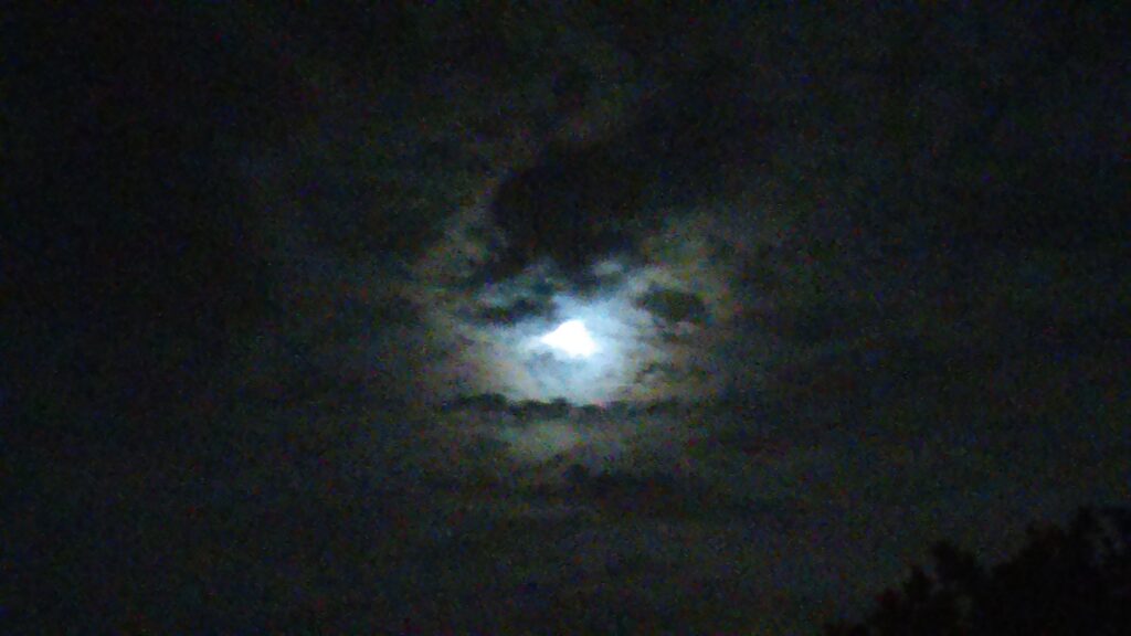 Moonlit sky with dark clouds.