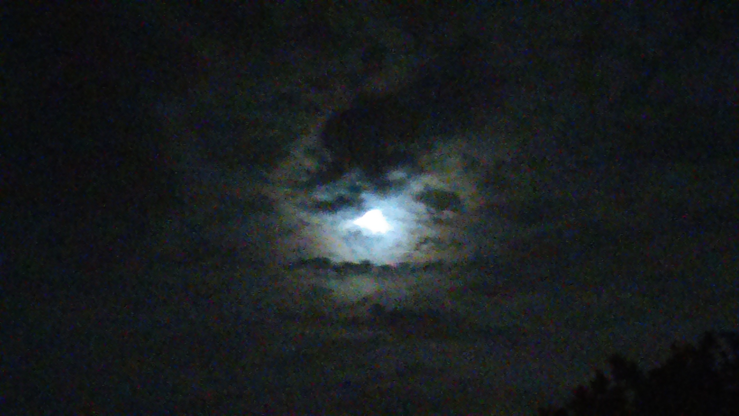 Moonlit sky with dark clouds.