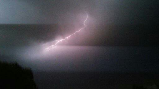 Lightning bolt in dark cloudy sky.