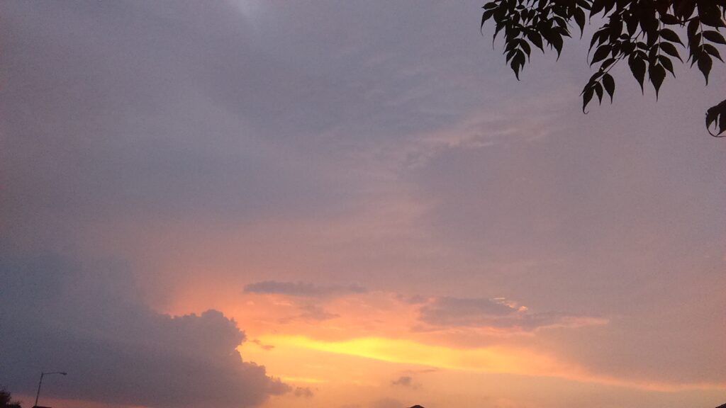 Sunset sky with dark and light clouds.