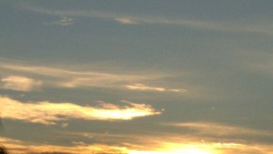 Sunset sky with scattered clouds.