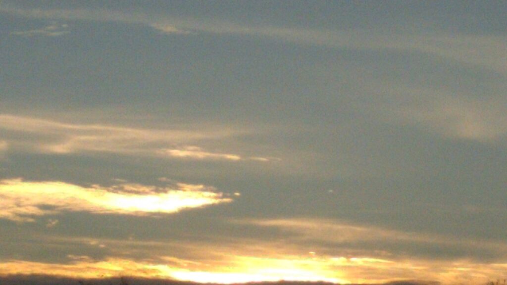 Sunset sky with scattered clouds.