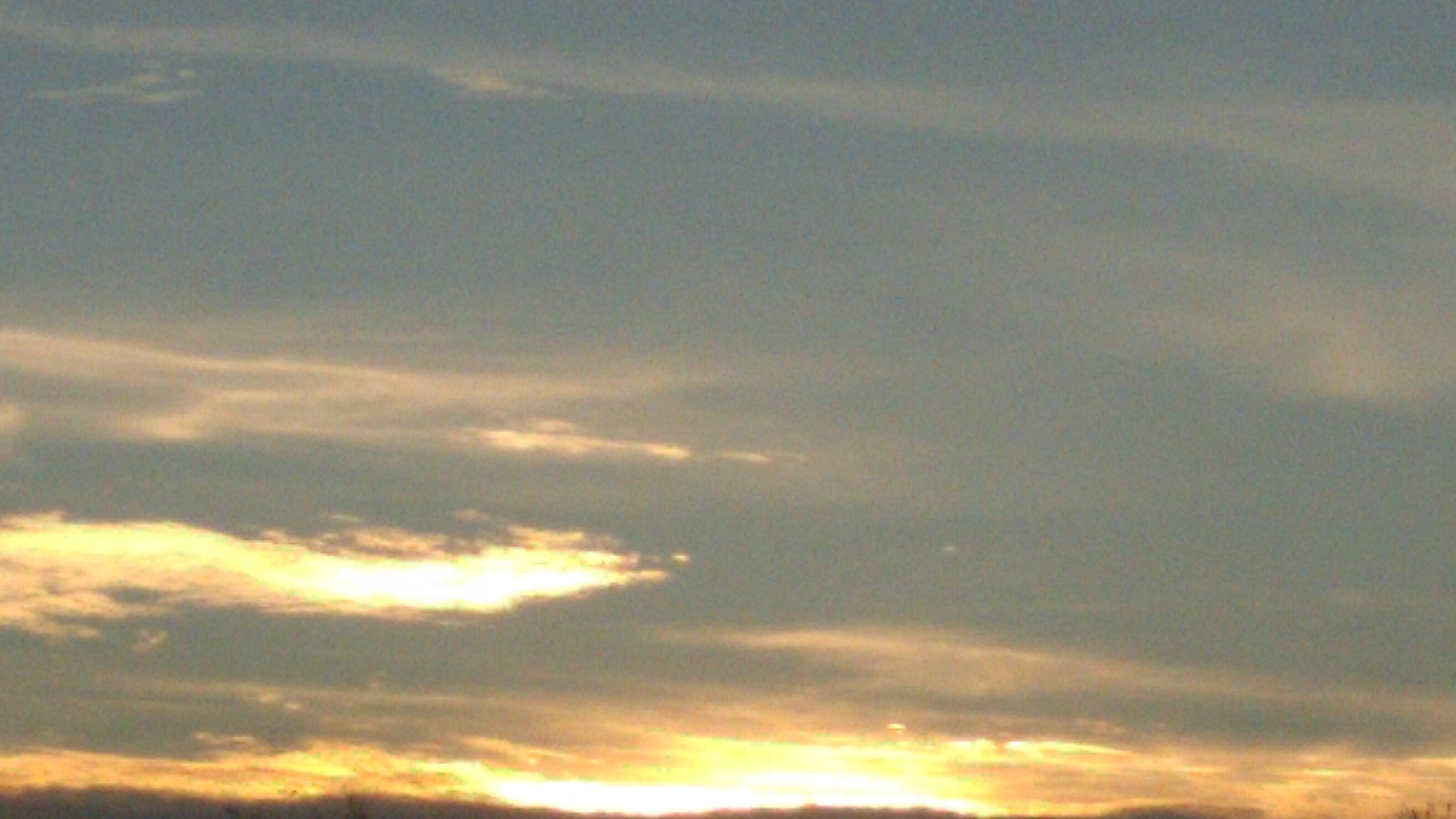 Sunset sky with scattered clouds.