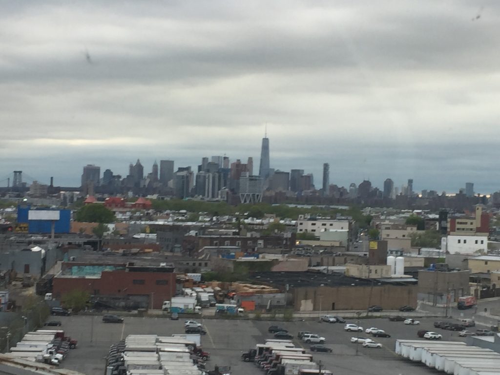 City skyline under cloudy sky, industrial foreground.