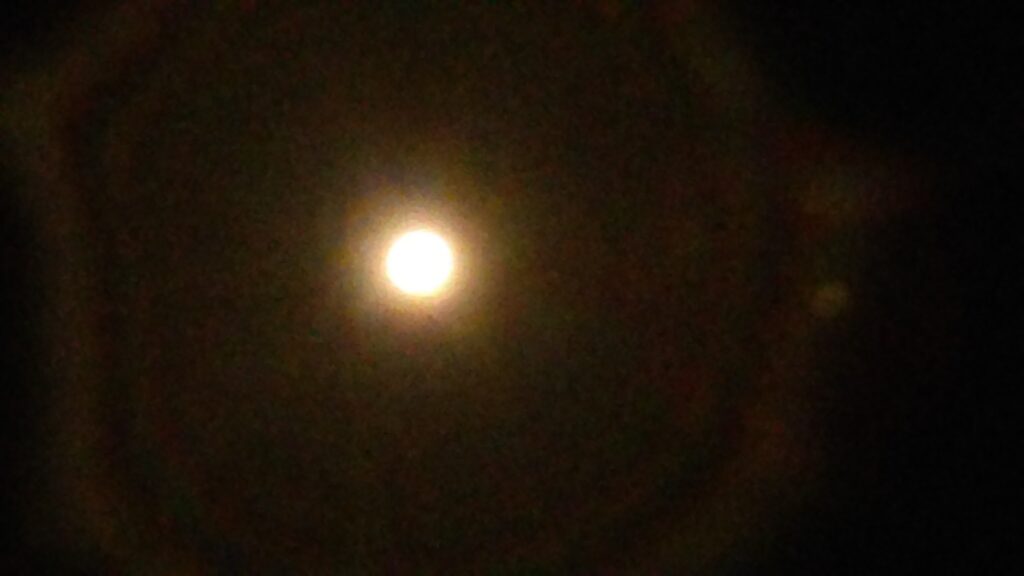 Bright moon in a dark night sky.