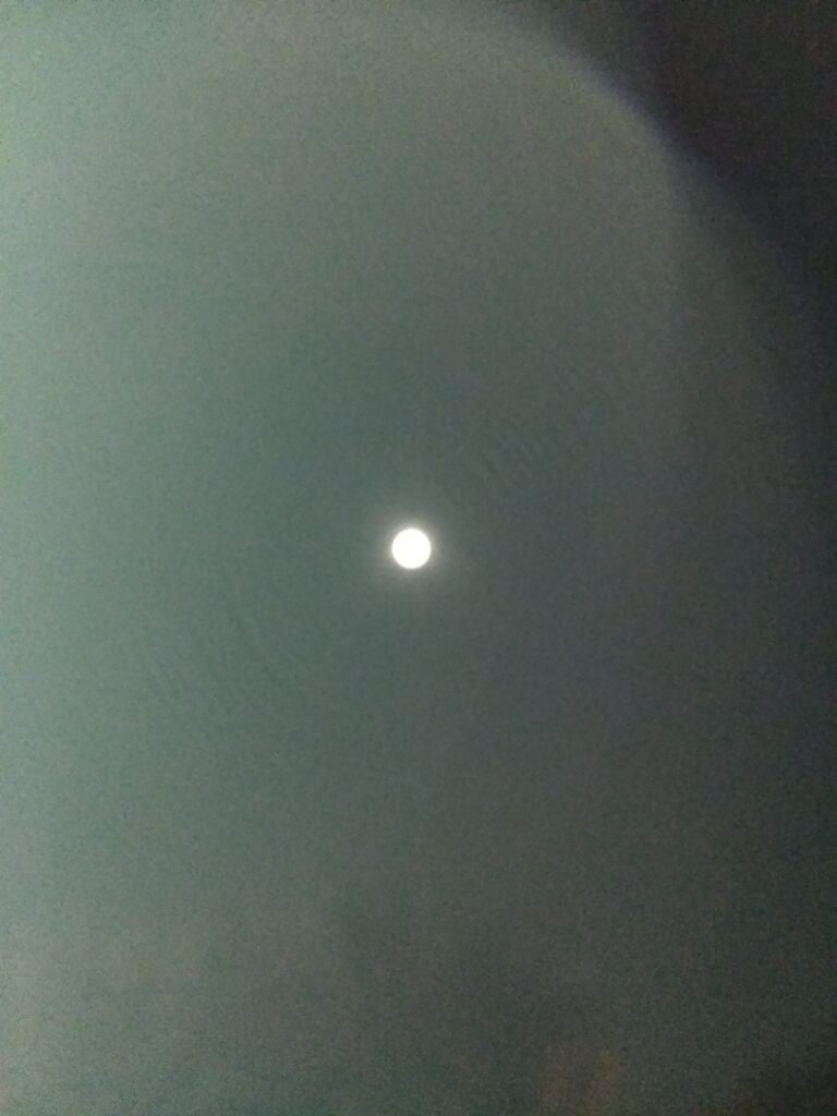 Bright moon in a dark night sky.