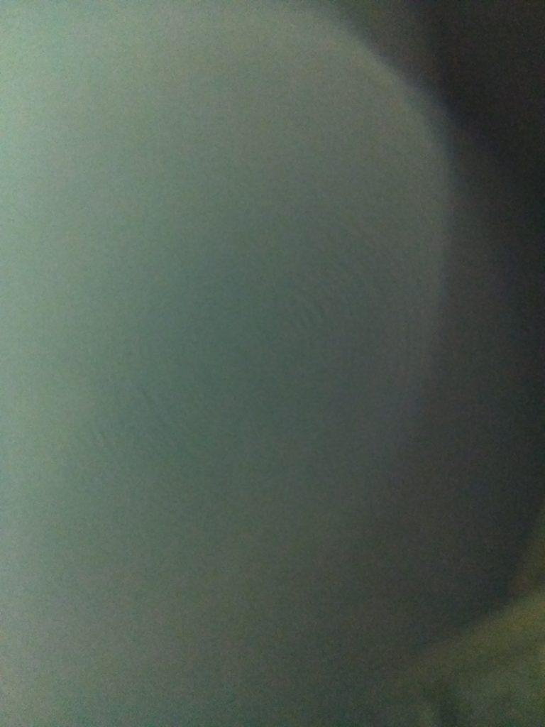 Blurry, abstract circular pattern in gray.