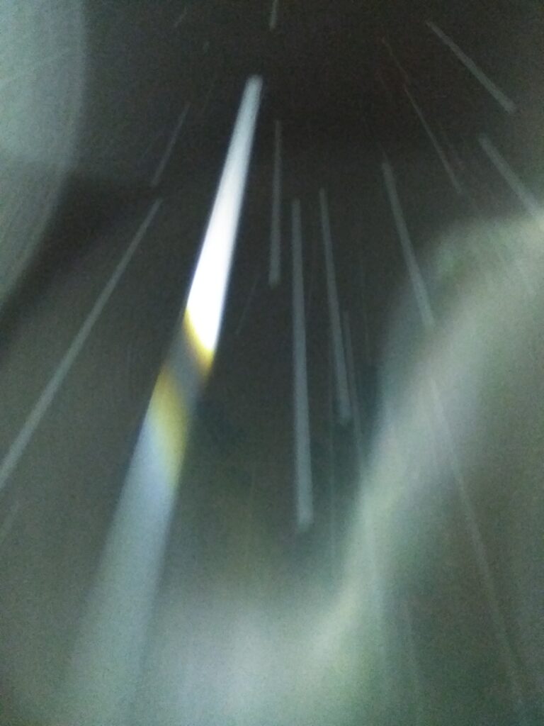 Abstract light streaks against dark background.
