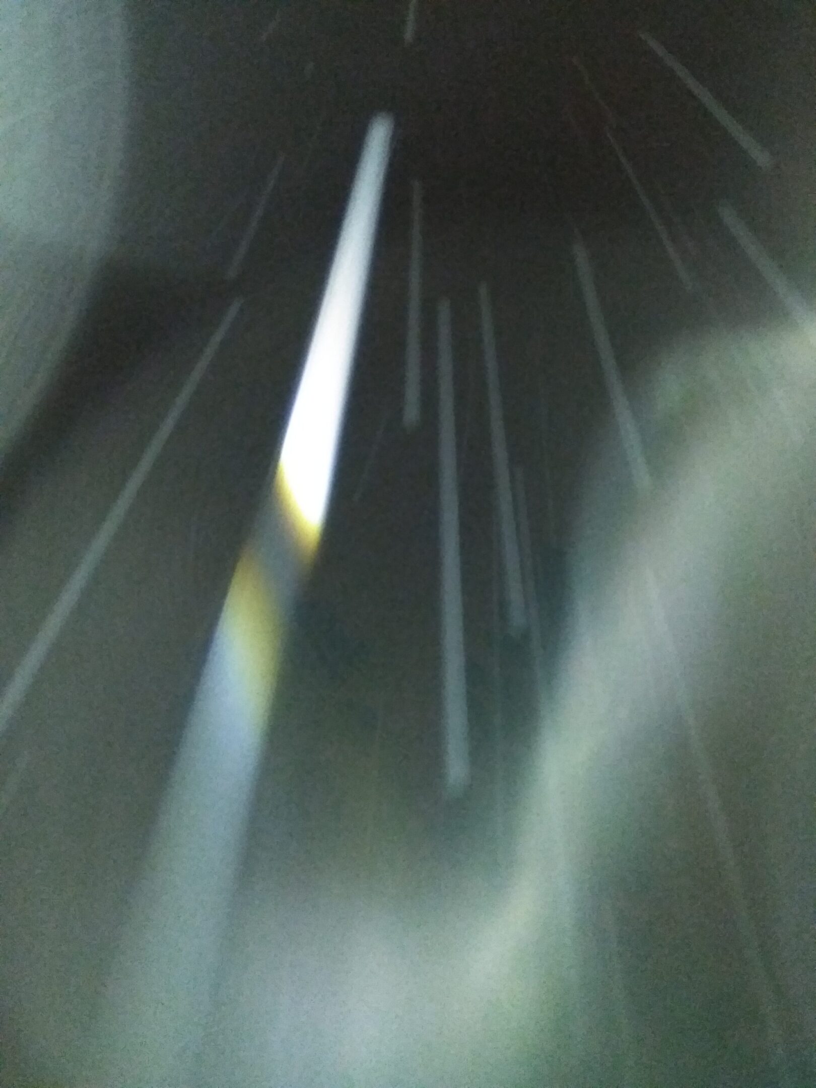 Abstract light streaks against dark background.