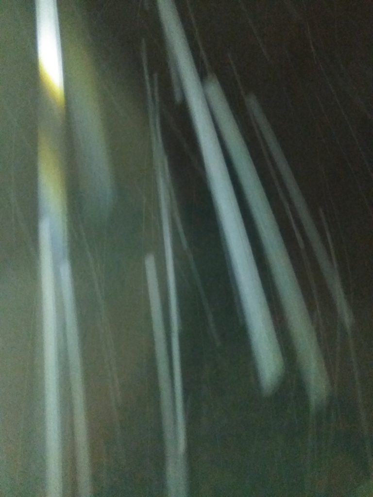 Blurry streaks of light in darkness.