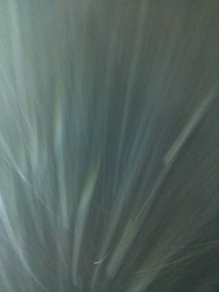 Abstract light streaks against a dark background.