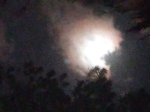 Cloudy night sky with bright moon.