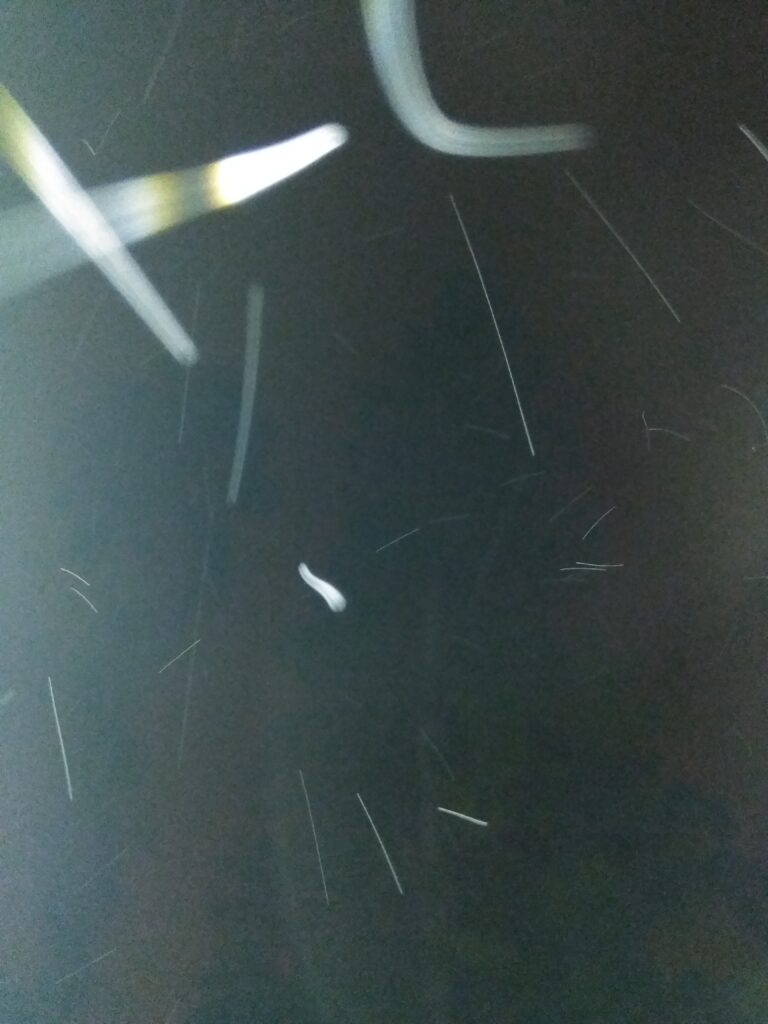Abstract light trails on a dark background.