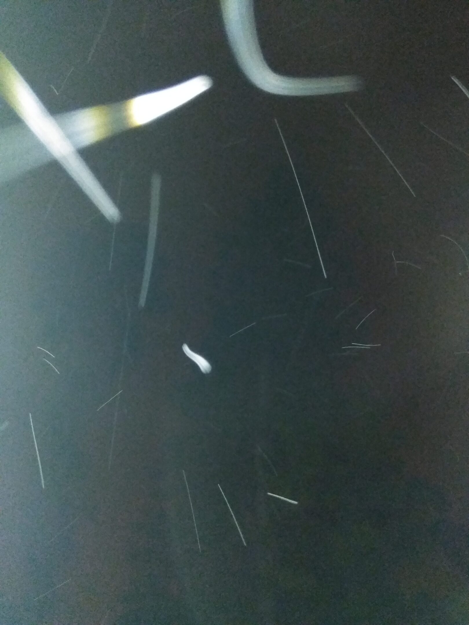 Abstract light trails on a dark background.