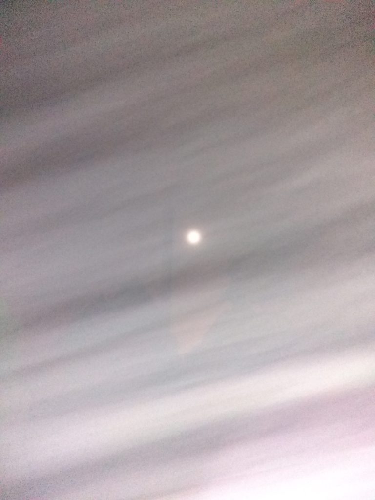 Blurry night sky with a bright spot.