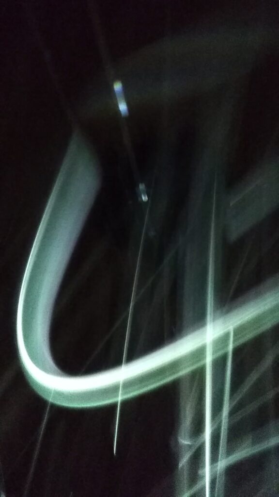 Blurred light streaks on a dark background.