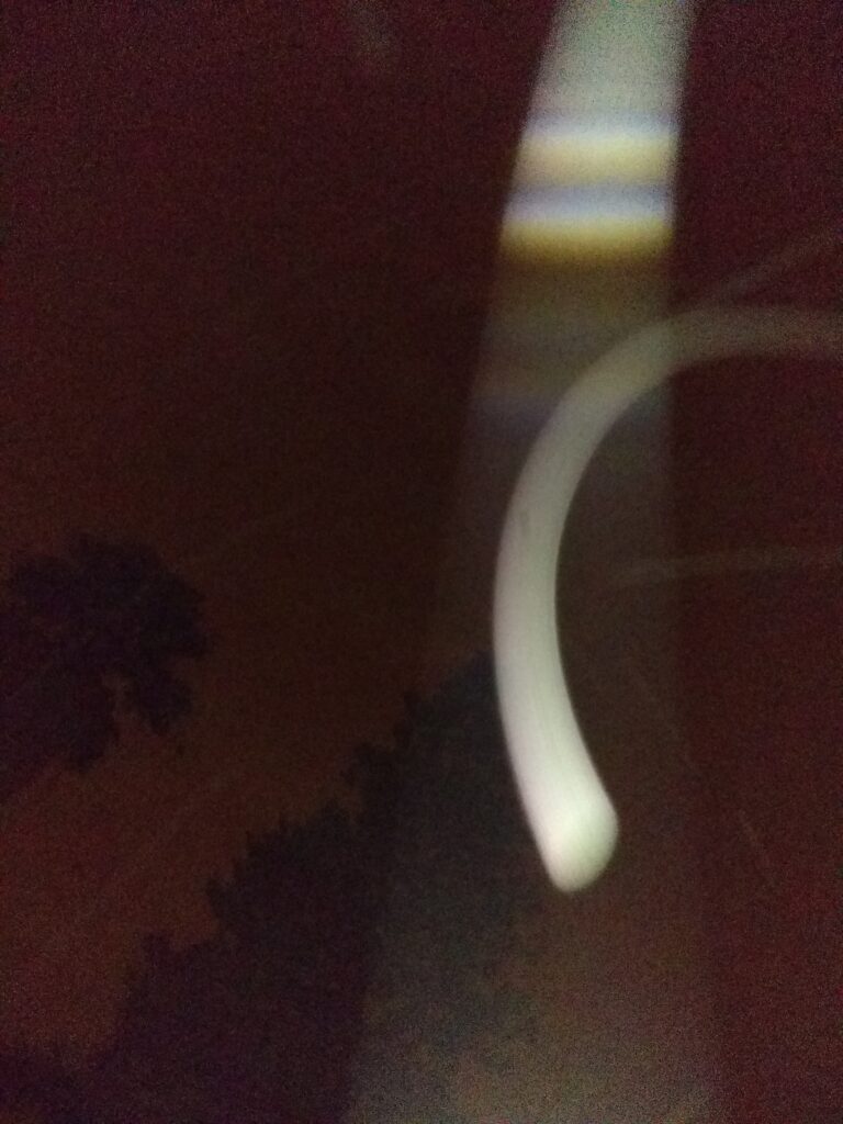 Abstract light streak in dark sky.