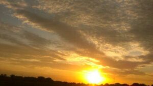 Sunset with vibrant orange and yellow sky.