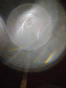 Blurred light circles with faint rainbow.