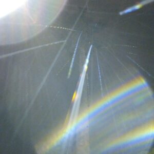 Abstract light patterns with rainbow streaks.