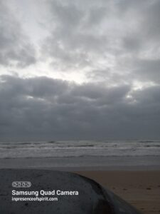 Cloudy beach with overcast sky.