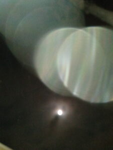 Blurry light circles with dark background.