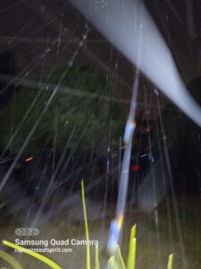 Rainy night with blurred light streaks.
