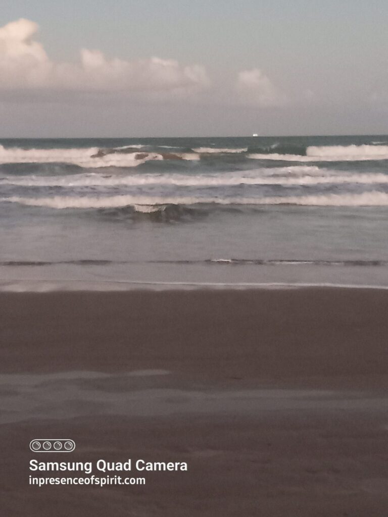Waves crashing on a sandy beach.