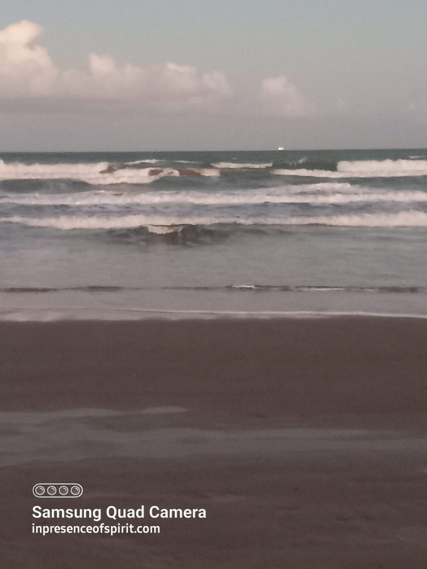 Waves crashing on a sandy beach.